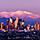 Skyline of LA with mountains behind the city at sunset. Los Angeles.